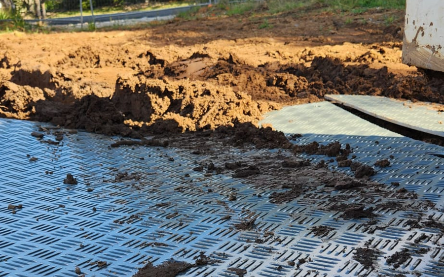 Ground protection mats creating a temporary access surface